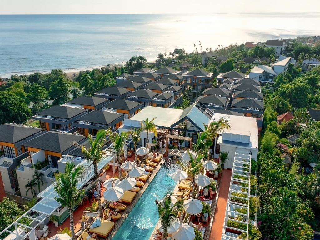 an aerial view of a resort with a pool at Secana Beachtown Resort & Villas in Canggu