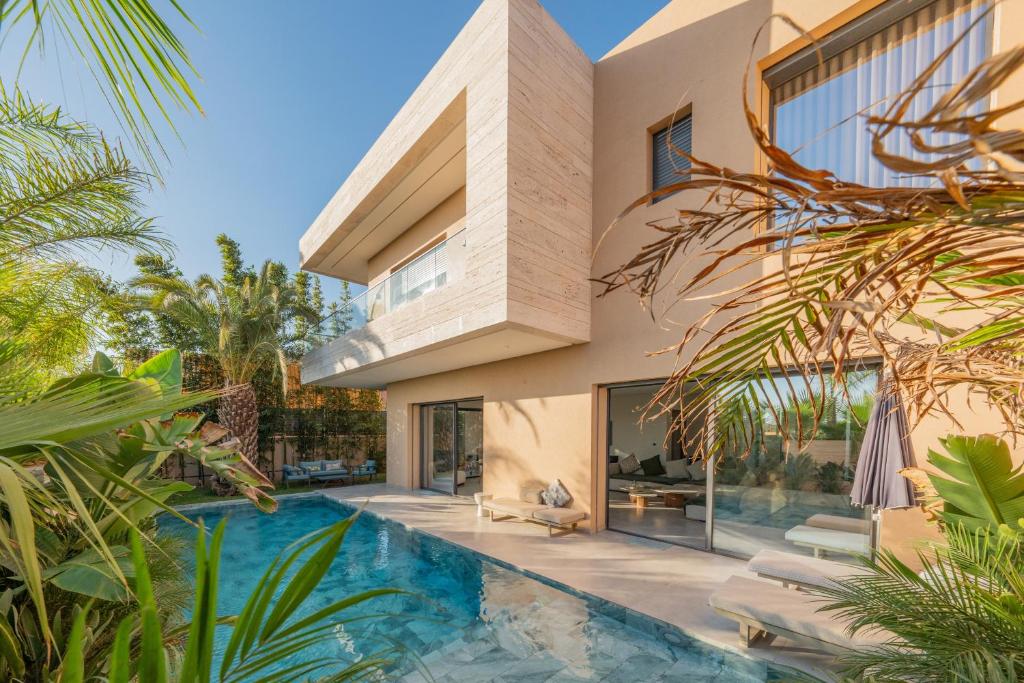 an exterior view of a house with a swimming pool at Villa Capella heated pool and cooker in Marrakesh