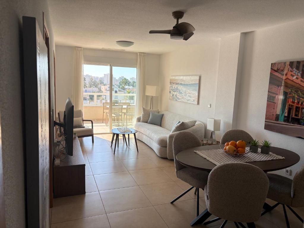 a living room with a couch and a table at Rio Nacimiento in Campoamor