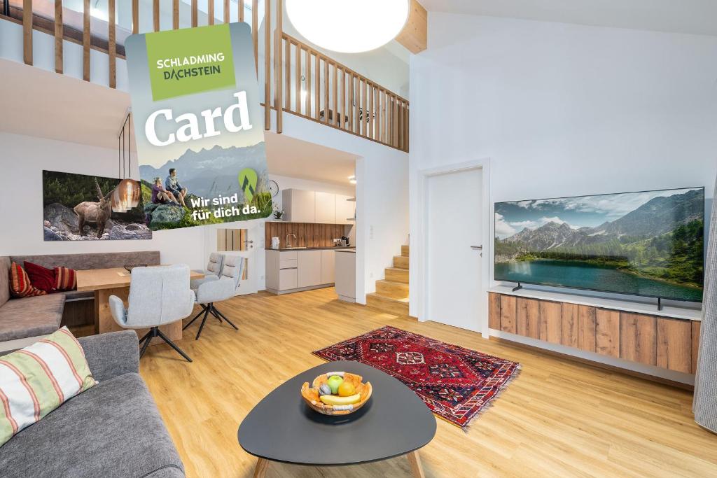 a living room with a couch and a table at Wiesenblick Residences - by myNests in Haus im Ennstal