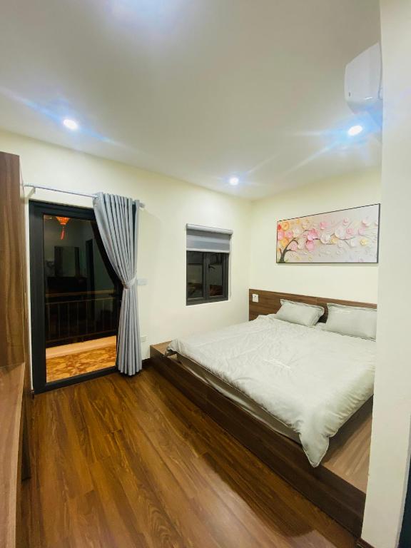a bedroom with a large bed and a window at CHIRU House Ninh Bình in Ninh Binh