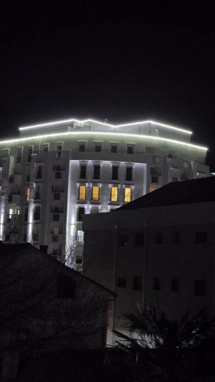 a building with lights on top of it at night at Ceca & Dimi Apartments 2 in Gevgelija
