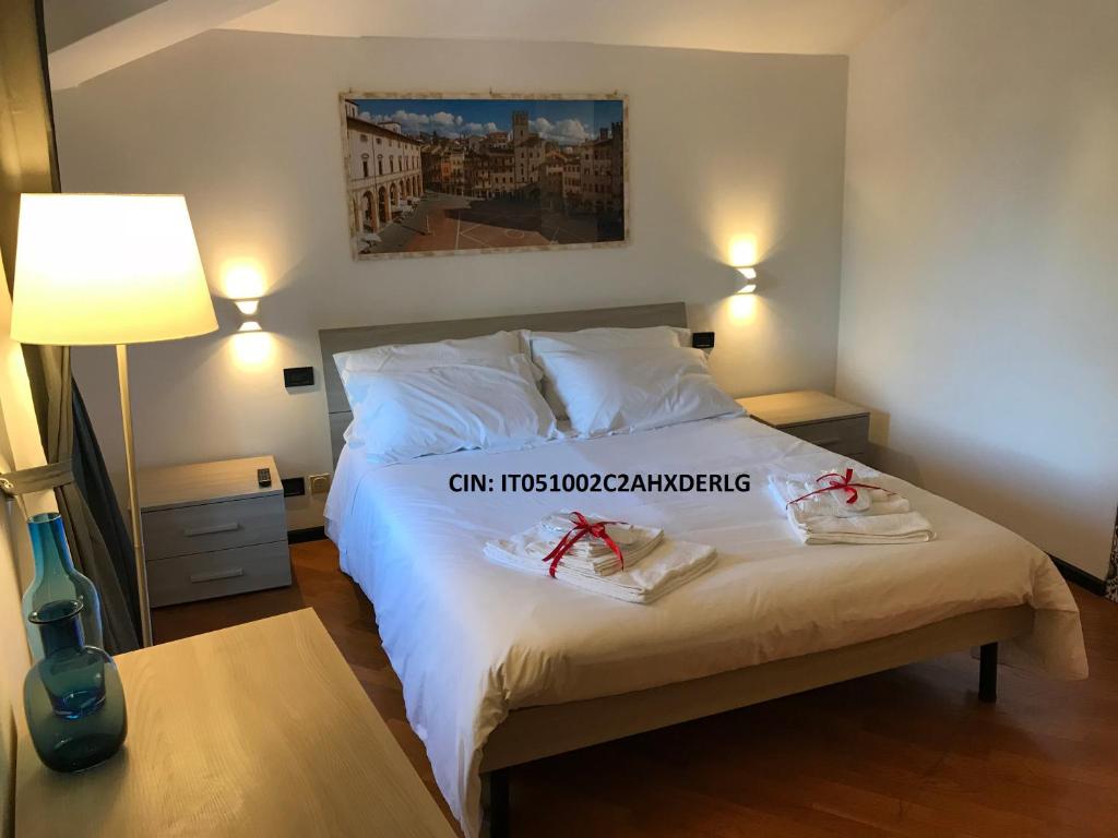 a bedroom with a bed with two shoes on it at San Clemente House in Arezzo