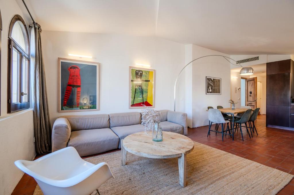 a living room with a couch and a table at Flateli Santa Clara 31 in Girona