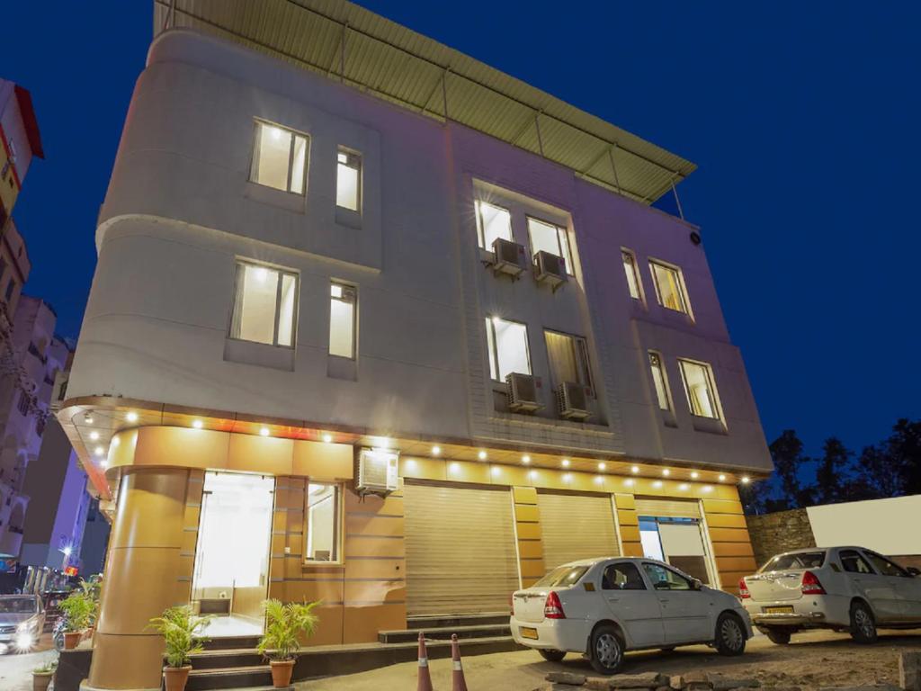 a building with cars parked in front of it at Hotel Anchal Villa By YB Hotel in Udaipur