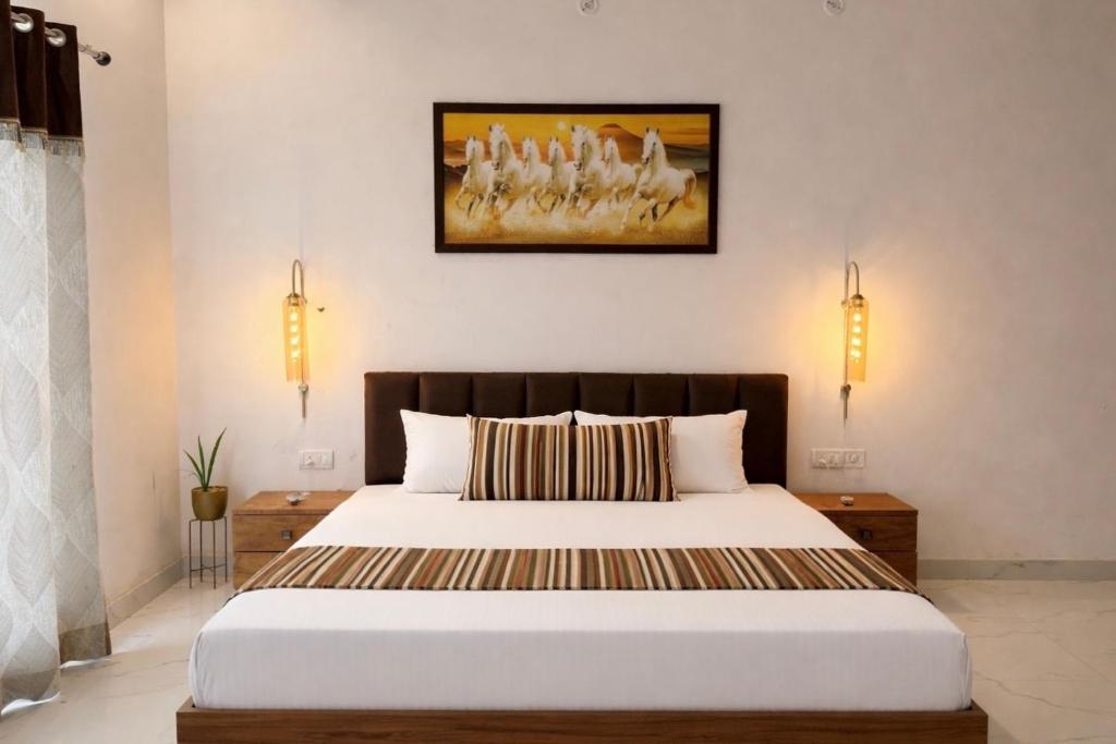 a bedroom with a bed and a painting on the wall at The RB's Farm in Fīrozābād