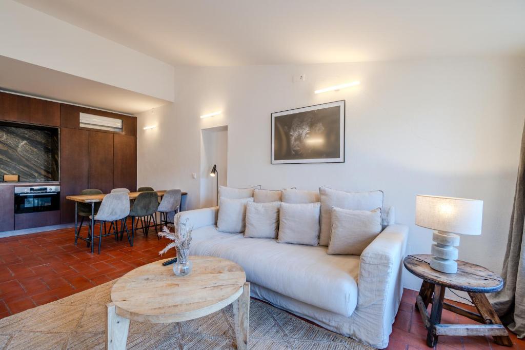 a living room with a couch and a table at Flateli Santa Clara 22 in Girona