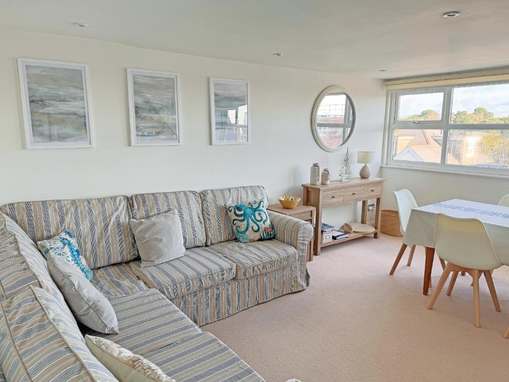 a living room with a couch and a table at Sandbourne in Bournemouth