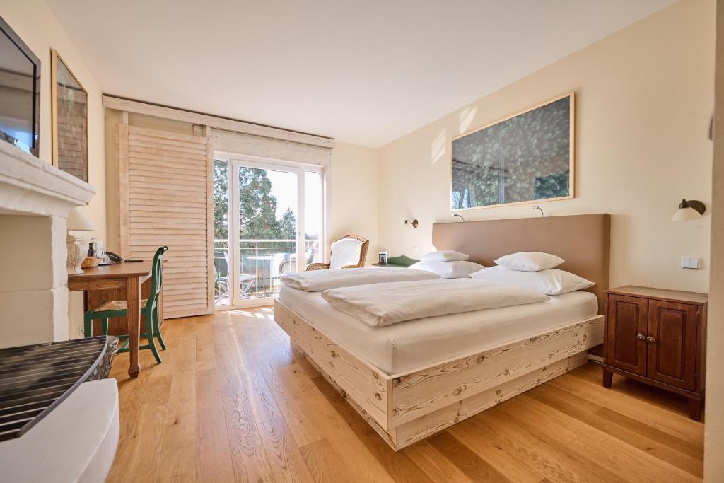 a bedroom with two beds and a fireplace at Hotel Hirschen in Freiburg-Lehen in Freiburg im Breisgau