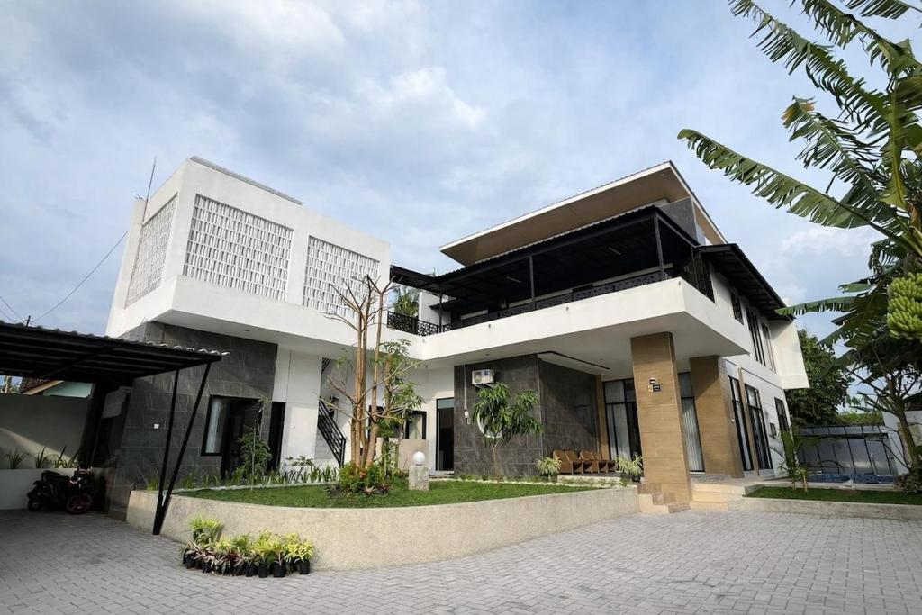 a large white building with a lot of windows at Spacious Tropical Villa with Pool and Bfast in Sleman
