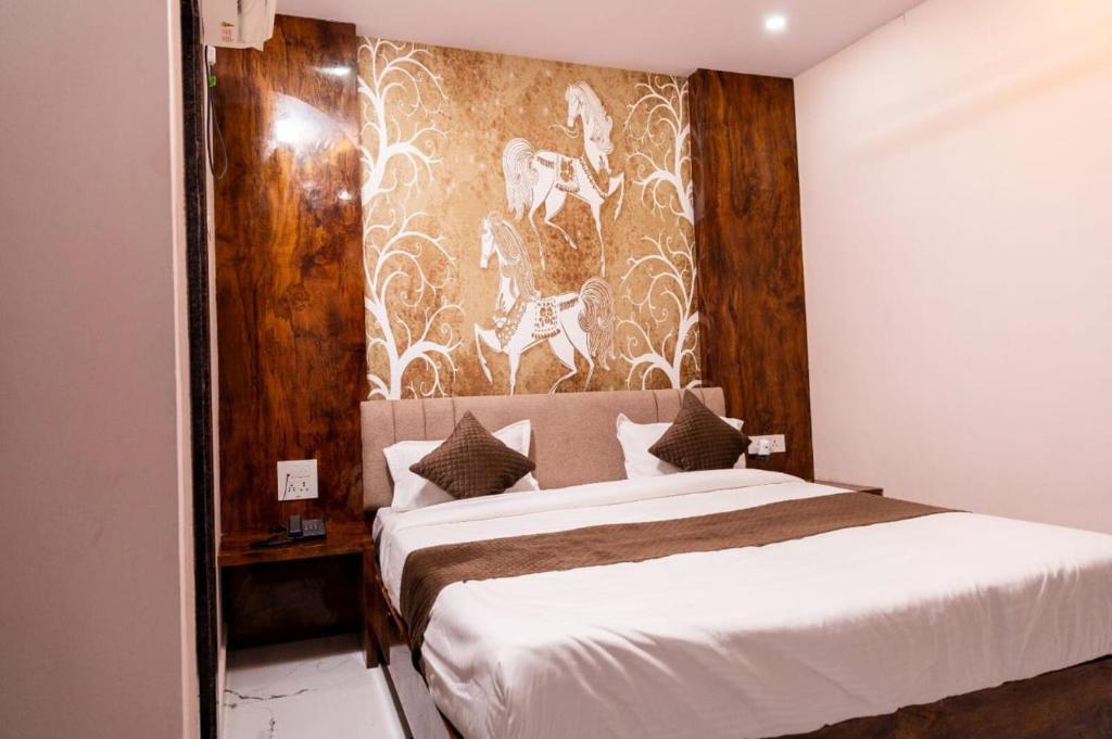 a bedroom with a large bed with a wall mural at hotel kargil inn in Satna