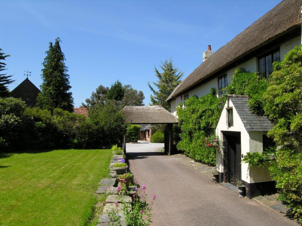 a house with a pathway leading to a yard at West Wing- Ukc4914 in Timberscombe