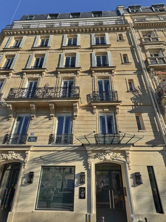 a large building with balconies on the side of it at Eiffel Yard Hotel in Paris