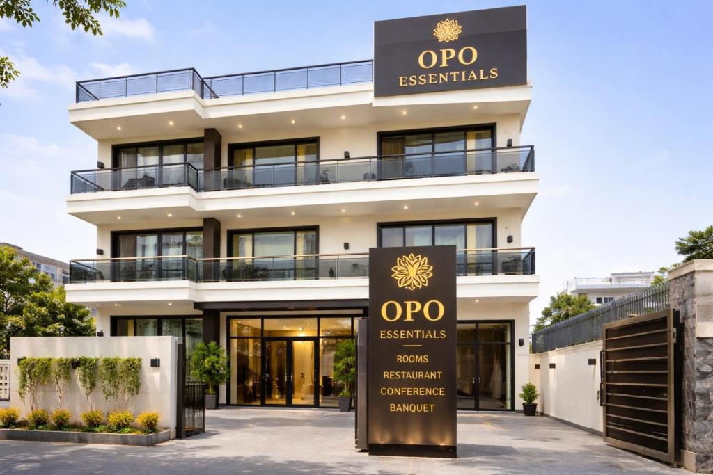an apartment building with a sign in front of it at OPO Essential, Sector 21 Gurgaon in Gurgaon
