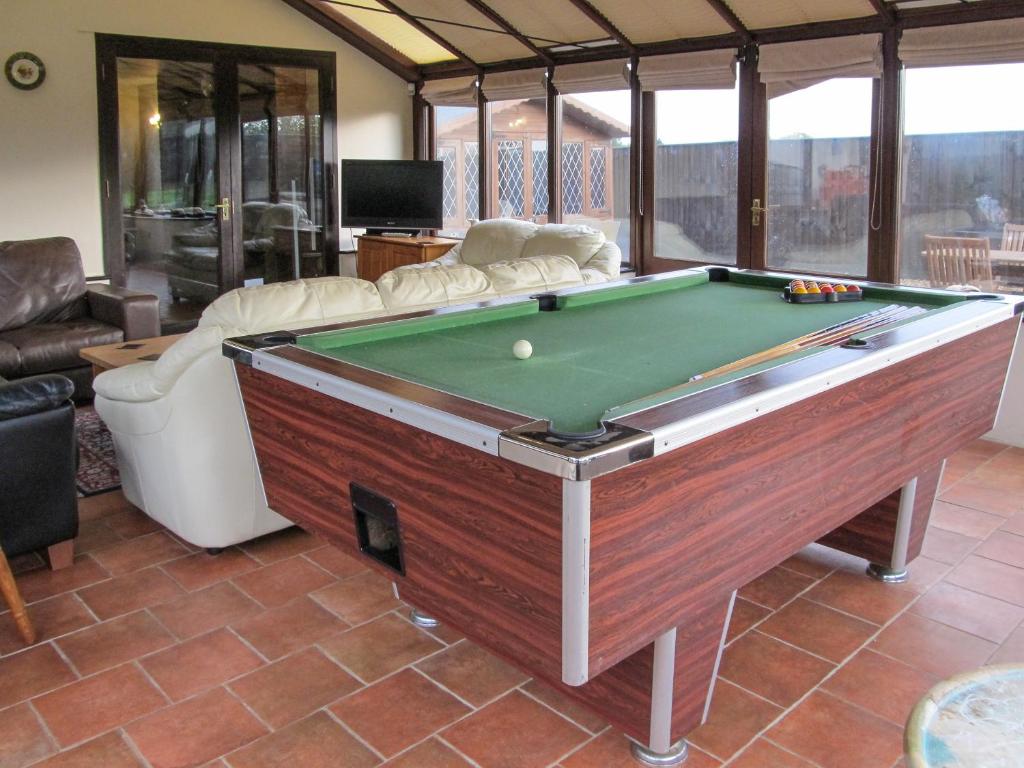 a living room with a pool table in it at Maytree Cottage in East Dereham
