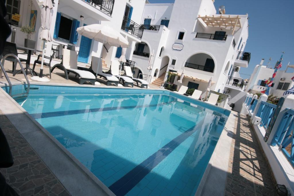 a large blue swimming pool in front of a building at Naxos Diol in Naxos Chora
