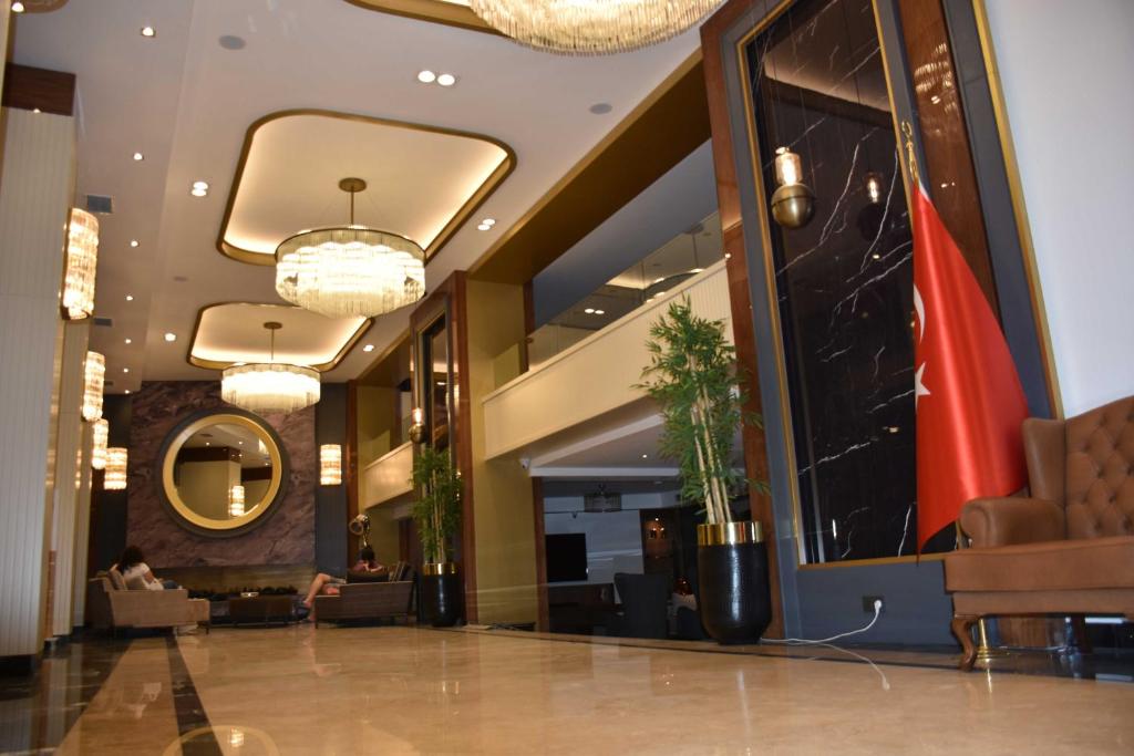 a lobby of a hotel with a flag on the wall at UK ANKARA Hotel in Ankara
