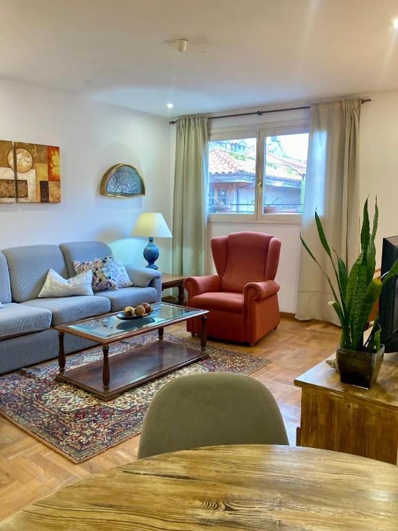 a living room with a couch and a table at Casco antiguo en Ribadesella in Ribadesella
