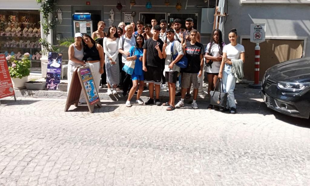 a group of people standing in front of a car at Theodora Hostel in Istanbul
