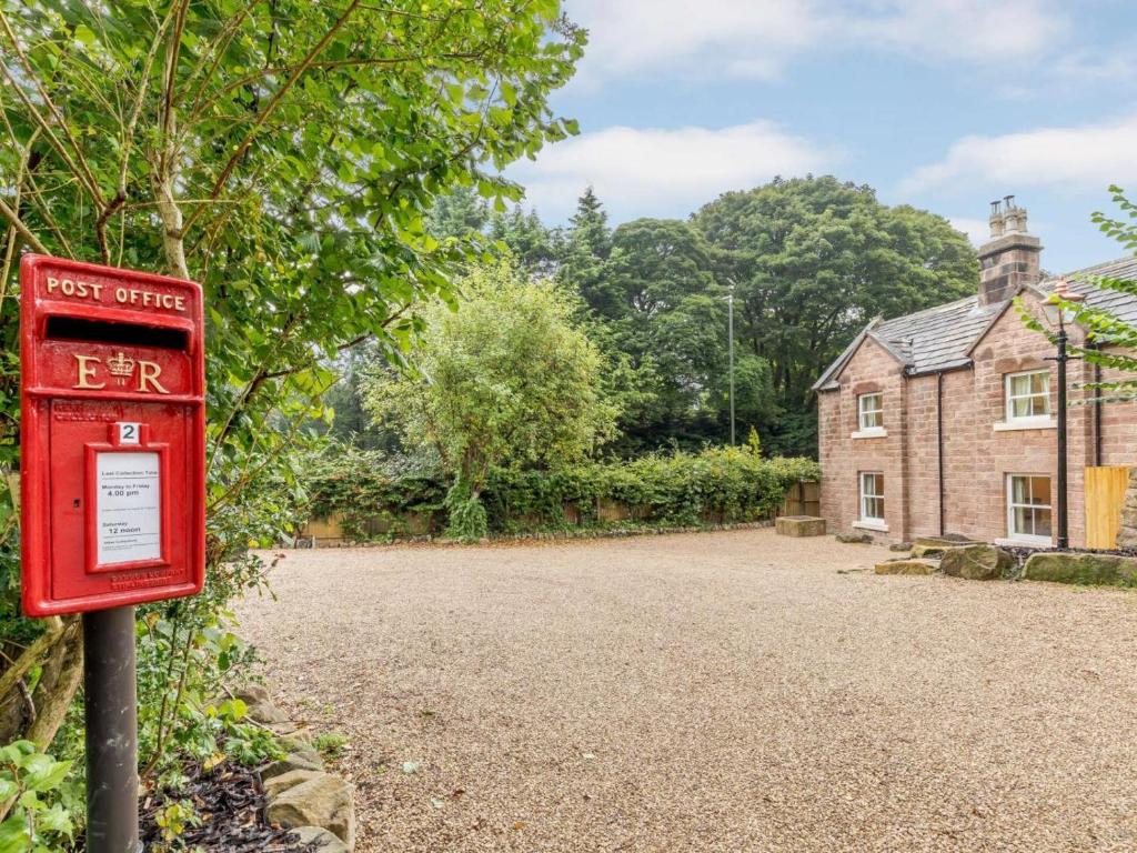 a red post box in front of a house at 4 Bed in Matlock oc-82198 in Cromford