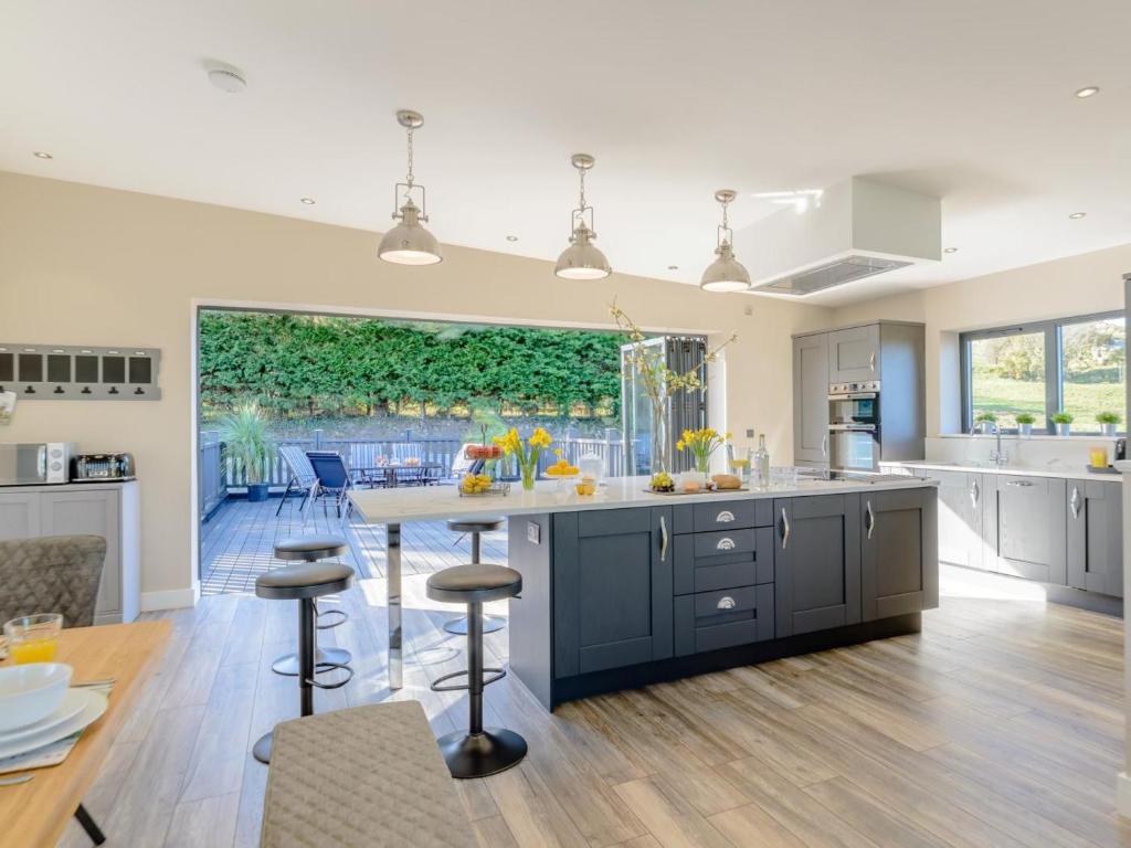 a kitchen with a large island with bar stools at 3 Bed in Belford oc-78057 in Ellington