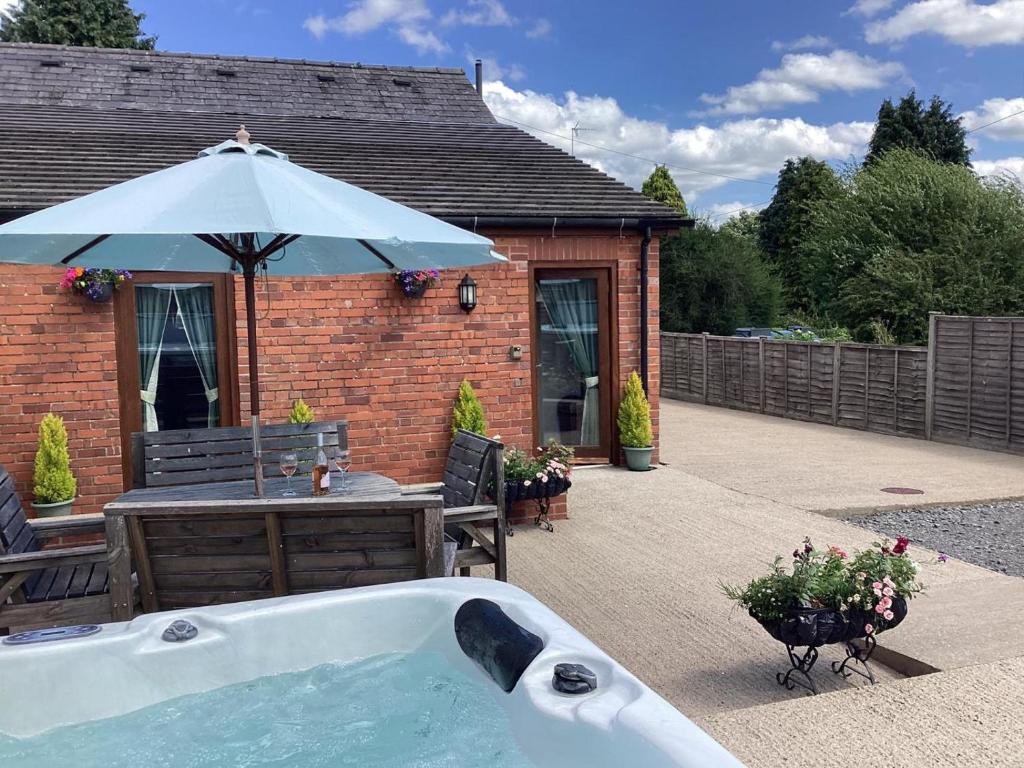 a bath tub in front of a house with an umbrella at 3 Bed in Ellesmere oc-94419 in Dodleston