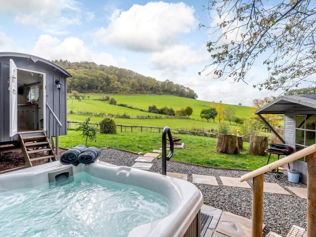 a bath tub with a view of a field at 1 Bed in Hereford oc-79576 in Byford