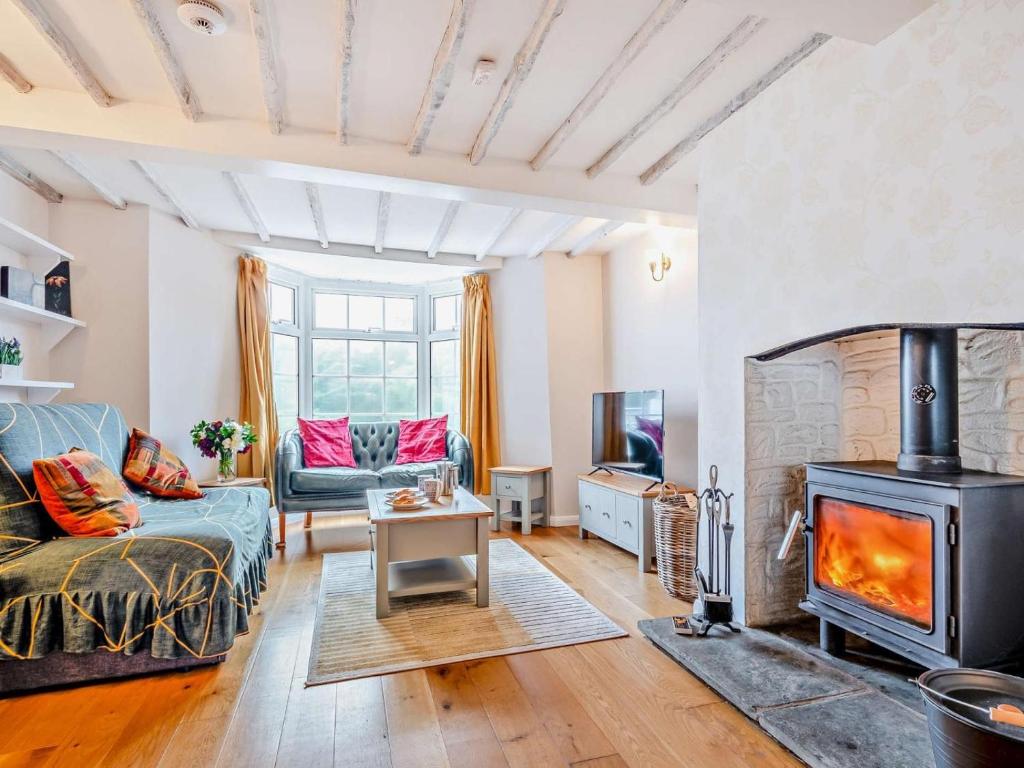 a living room with a couch and a wood stove at 2 Bed in Swindon oc-93489 in Bishopstone