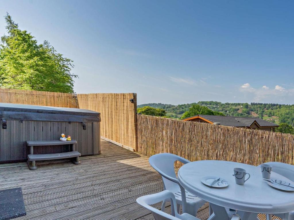 a patio with a table and chairs on a wooden deck at 2 Bed in Blakeney oc-54765 in Awre