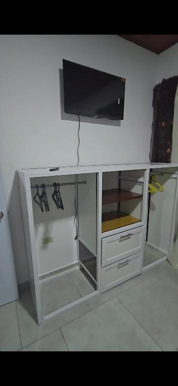 a white cabinet with a tv on top of it at GK Luxury Stay in Cruce de Veragua