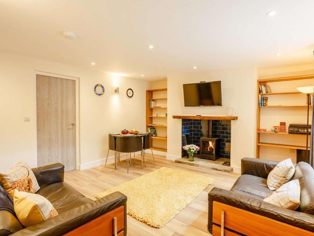 a living room with a couch and a fireplace at 2 Bed in Ilkley oc-89554 in Ilkley