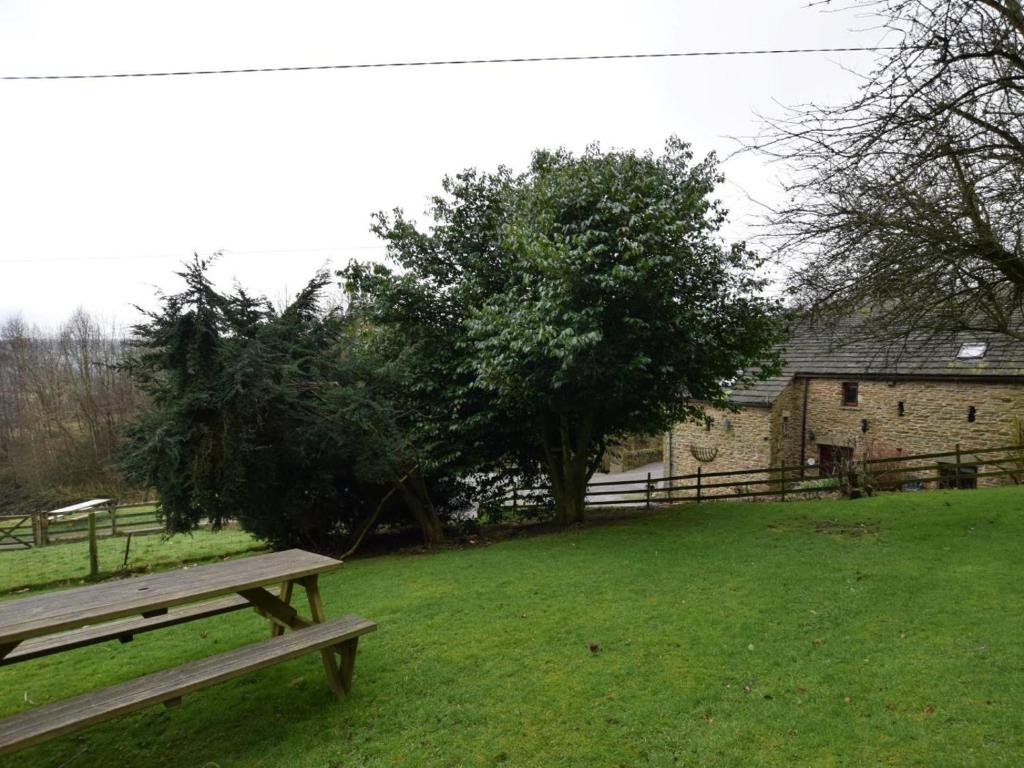a wooden bench sitting in the grass in a field at 3 Bed in Hope Valley oc-pk432 in Aston