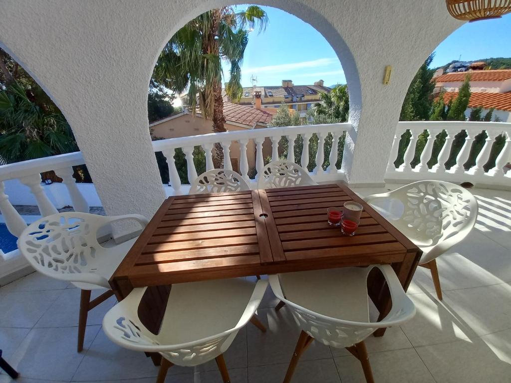 a wooden table and chairs on a balcony at Marcolina, 2 in Alcalà de Xivert
