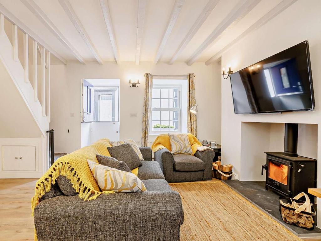 a living room with a couch and a fire place at 2 Bed in Aberdovey oc-91962 in Aberdyfi