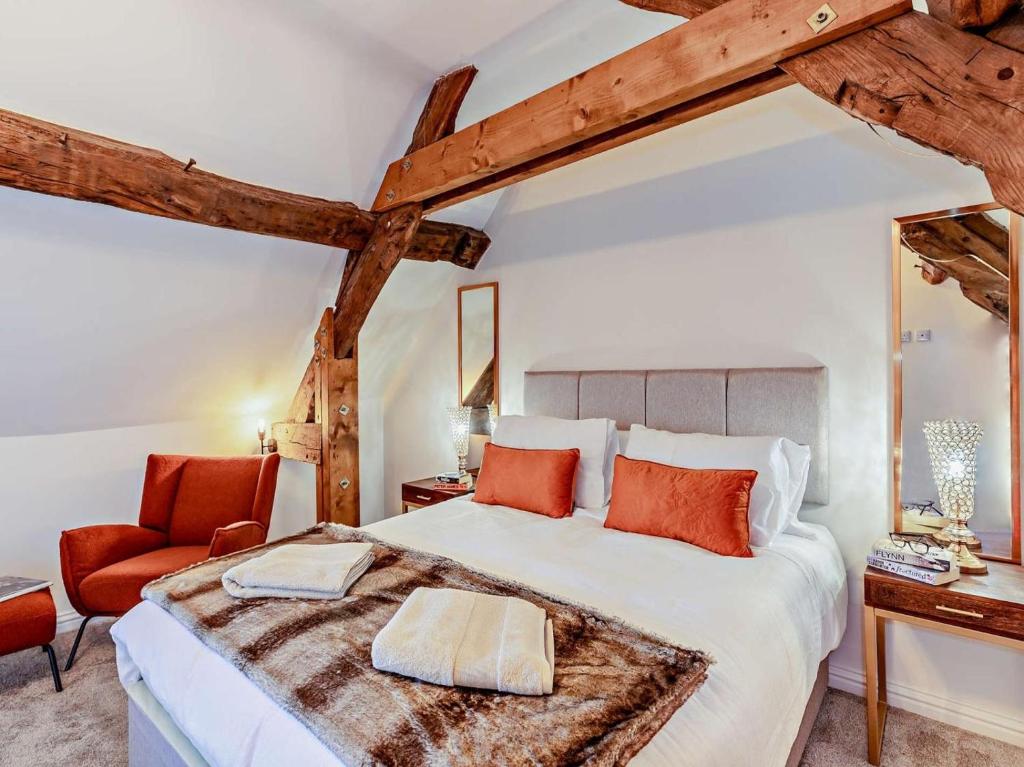 a bedroom with a large bed and a chair at 2 Bed in Warwick oc-93085 in Warwick