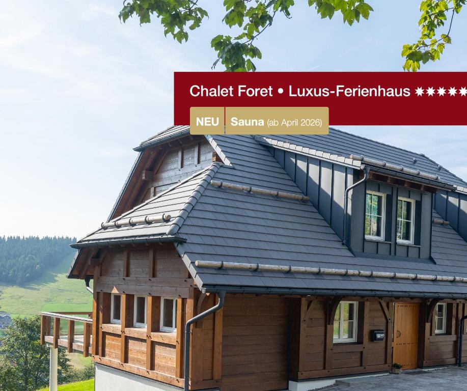 a house with a metal roof on top of it at Chalet Foret - Ferienhaus in Todtnauberg