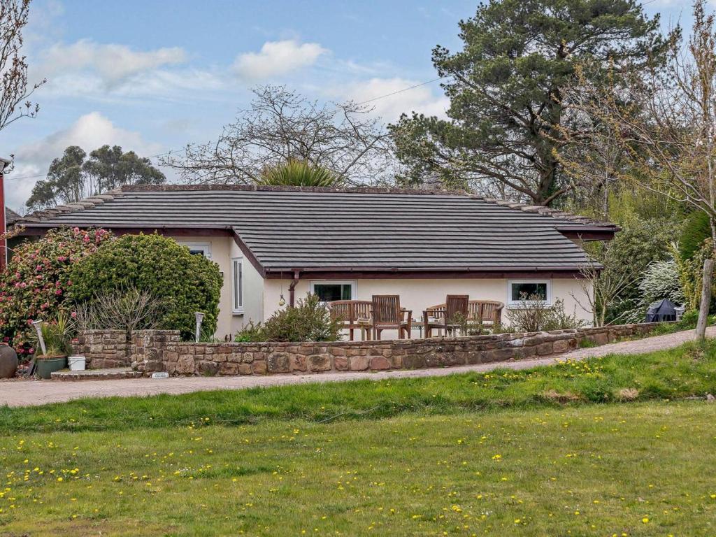 a small white house with a black roof at 3 Bed in Monmouth oc-52149 in Welsh Newton Common