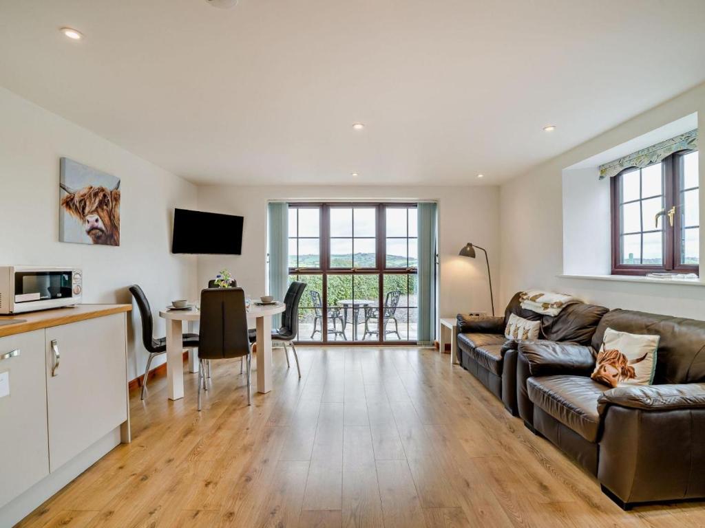 a living room with a couch and a table at 1 Bed in Bristol oc-72835 in Chew Magna