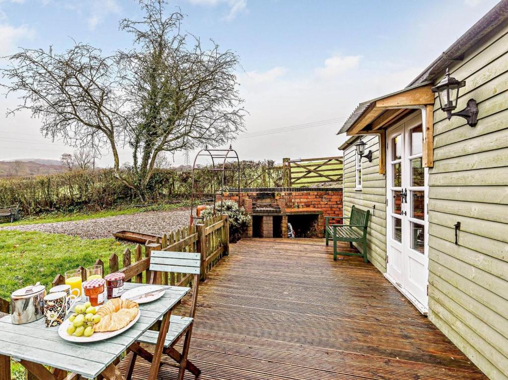 a wooden deck with a table with food on it at 1 Bed in Leighton oc-80727 in Leighton