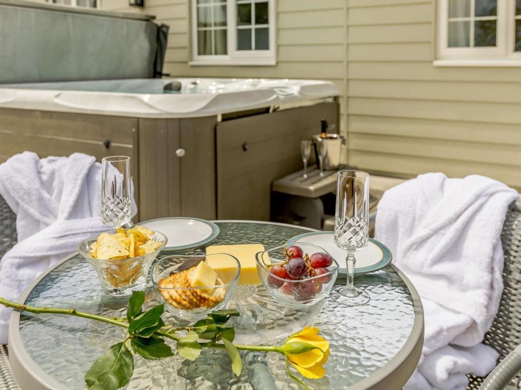 a glass table with bowls of fruit on it at 1 Bed in Cinderford oc-88272 in Cinderford