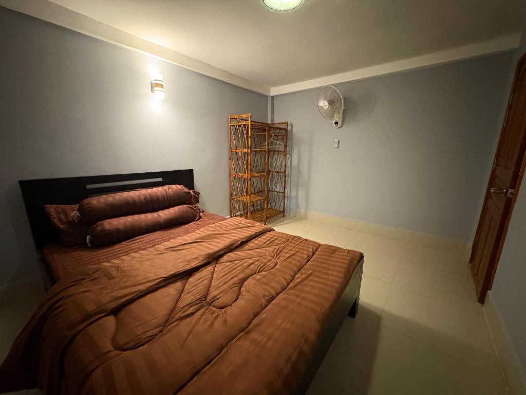 a bedroom with a bed with pillows on it at Wheelezz in Kep