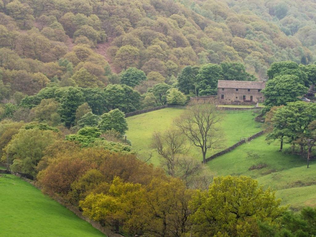 an old house in the middle of a green field at 2 Bed in High Peak oc-pk551 in Hayfield