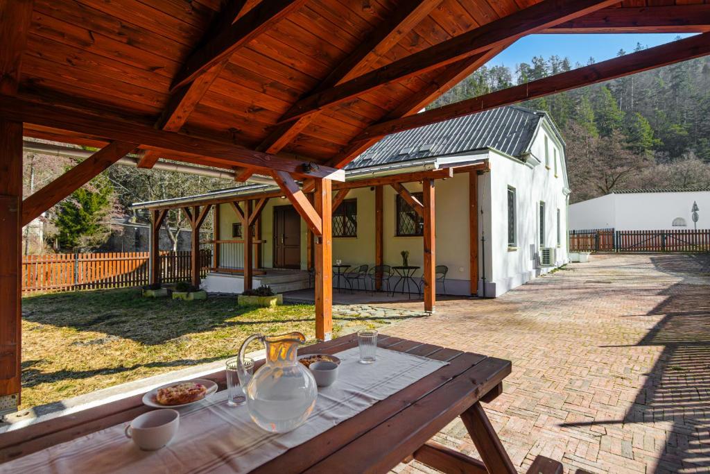 a wooden table in front of a house at Villa Pontis Rabštejn nad Střelou in Rabštejn nad Střelou