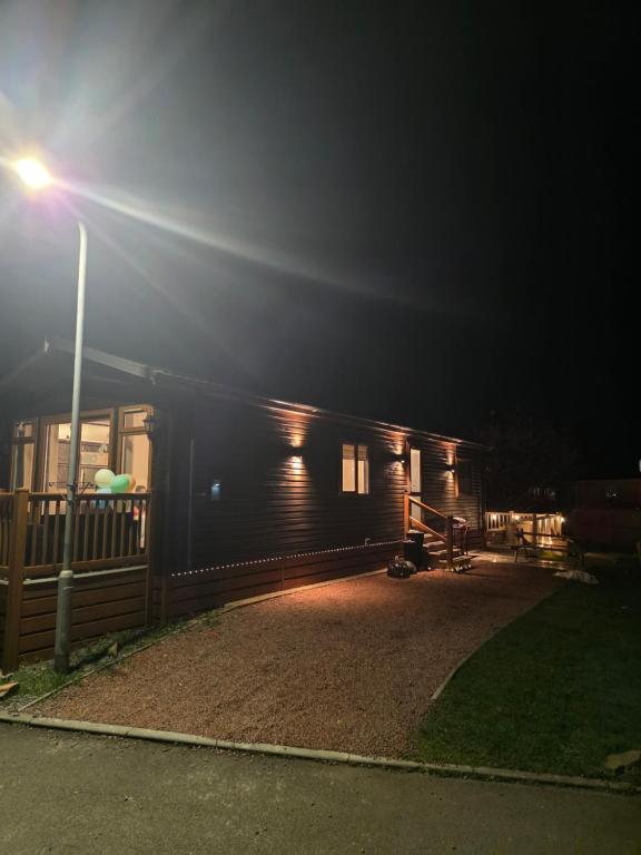 a small cabin at night with a street light at Dottys lodge in Felton
