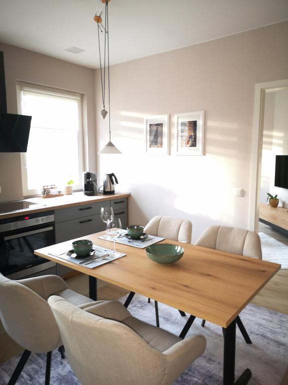 a living room with a wooden table and chairs at Superior - Appartement Amélie in Potsdam