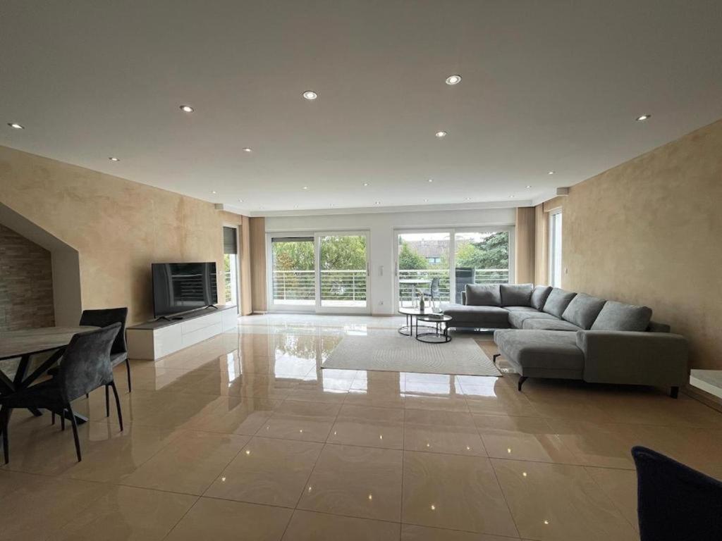 a large living room with a couch and a table at Stylish spacious residence in Düsseldorf in Düsseldorf