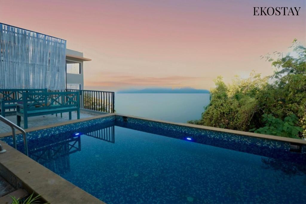 a swimming pool with a view of the water at EKOSTAY - Eternal Wave in Lonavala