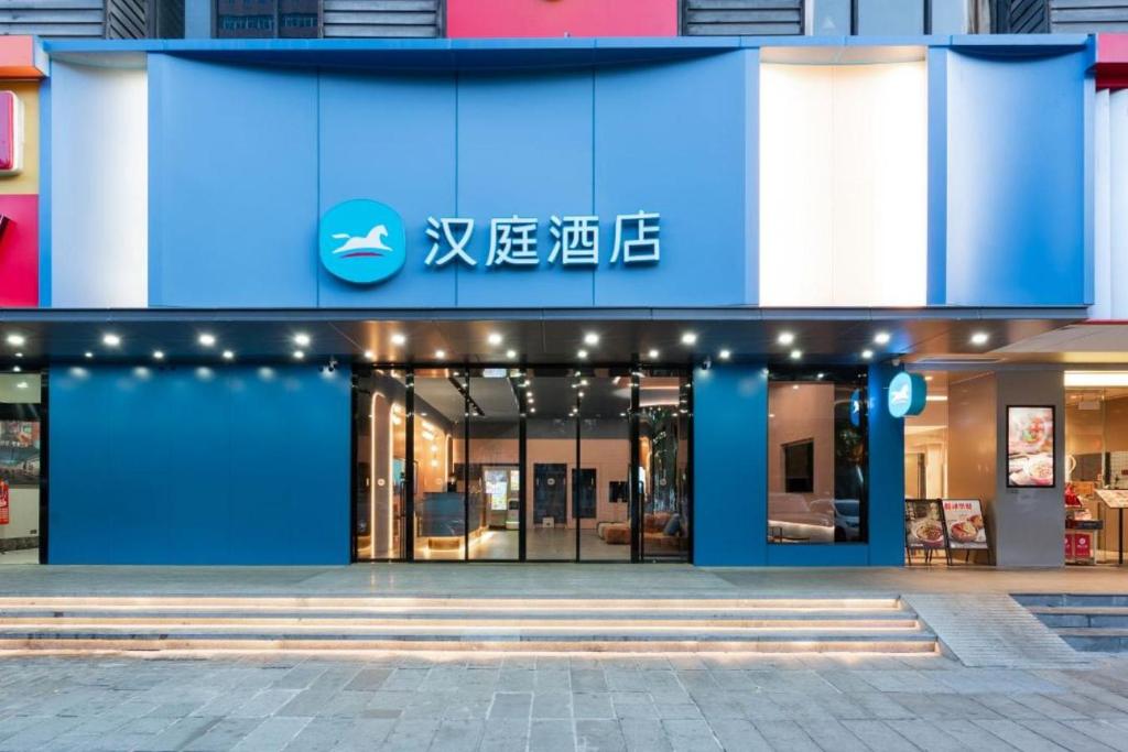 a blue building with a sign on the front of it at Hanting Hotel Guangzhou Tianhe in Guangzhou