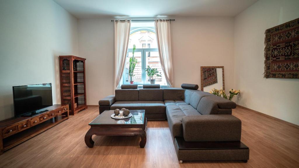 a living room with a couch and a coffee table at Peony Apartment in Kroměříž