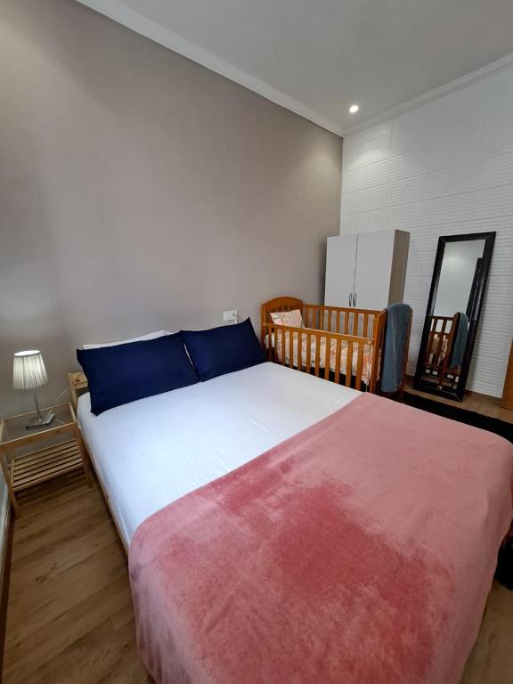 a bedroom with a large bed with blue and red sheets at Central Tangier , 3xBedroom , Apartment, Historic Medina, Margarita in Tangier